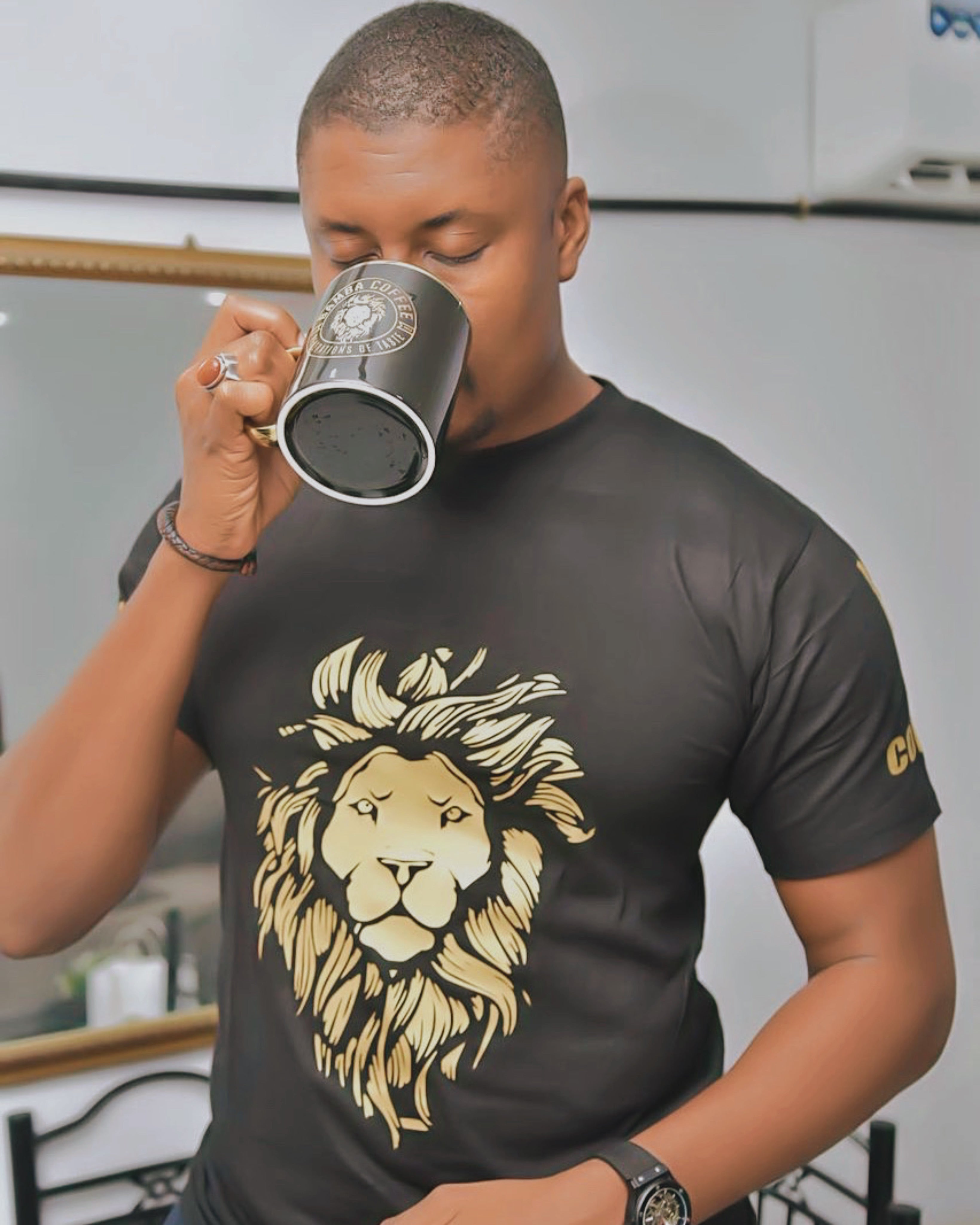  Man enjoying Bamba Coffee in black branded cup


